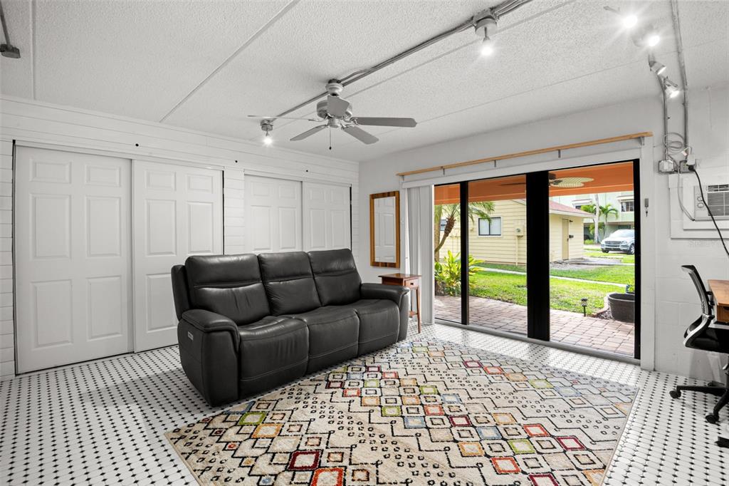 529 Sandy Hook Road Treasure Island, FL 33706 - Photo 39 of 55 a living room with furniture and a floor to ceiling window