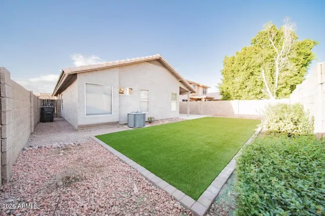 a view of a backyard with plants and a garden