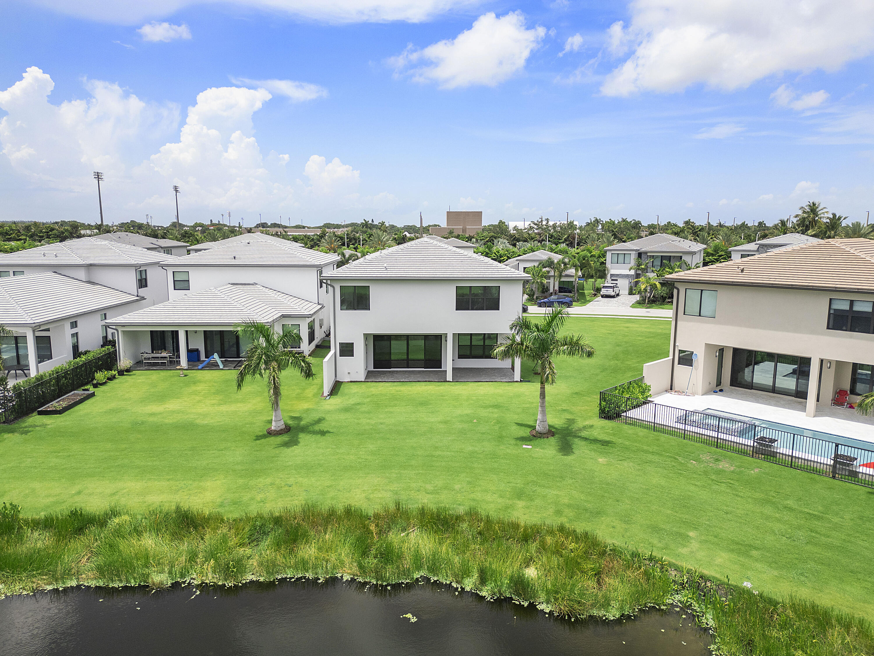 9322 Sunflower Mdw Road Boca Raton, FL 33434 - Photo 56 of 87 a front view of a house with a garden and yard