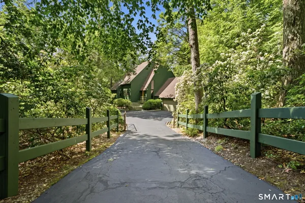 a view of a street with large trees