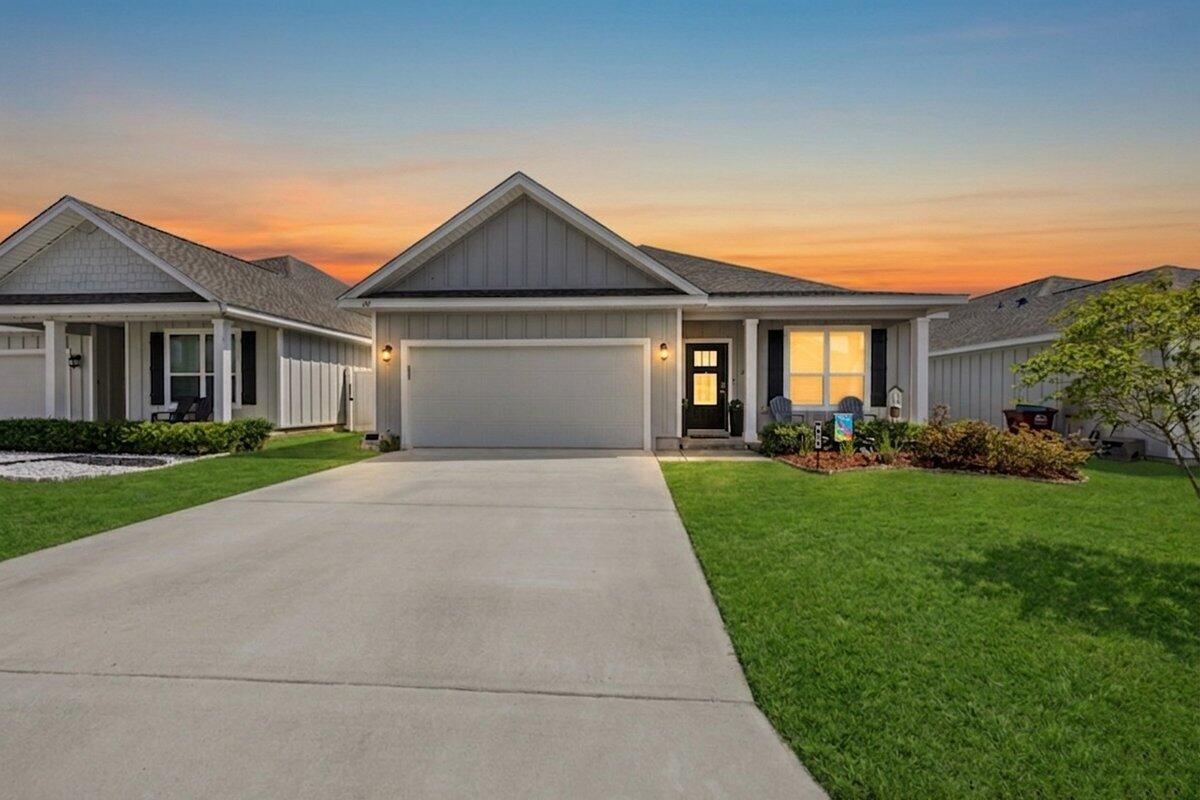 211 Lyla Lane Crestview, FL 32539 - Photo 1 of 38 a front view of a house with a yard and garage