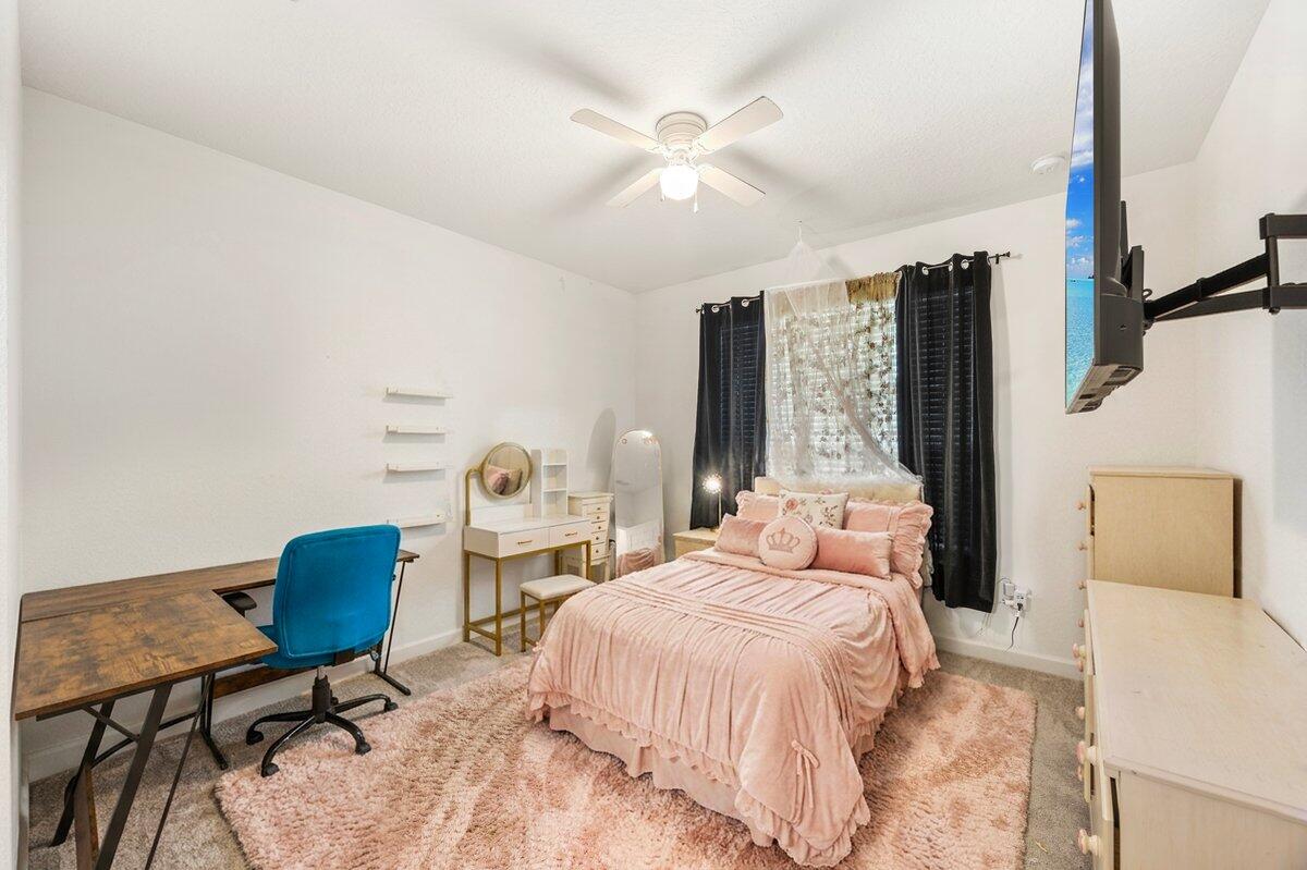 211 Lyla Lane Crestview, FL 32539 - Photo 4 of 38 a bedroom with a bed and a chair