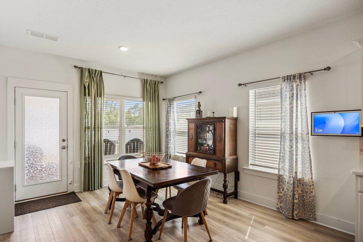 211 Lyla Lane Crestview, FL 32539 - Photo 10 of 38 a view of a dining room with furniture window and wooden floor