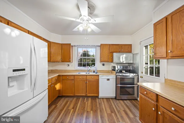 a kitchen with stainless steel appliances granite countertop a stove oven and white cabinets