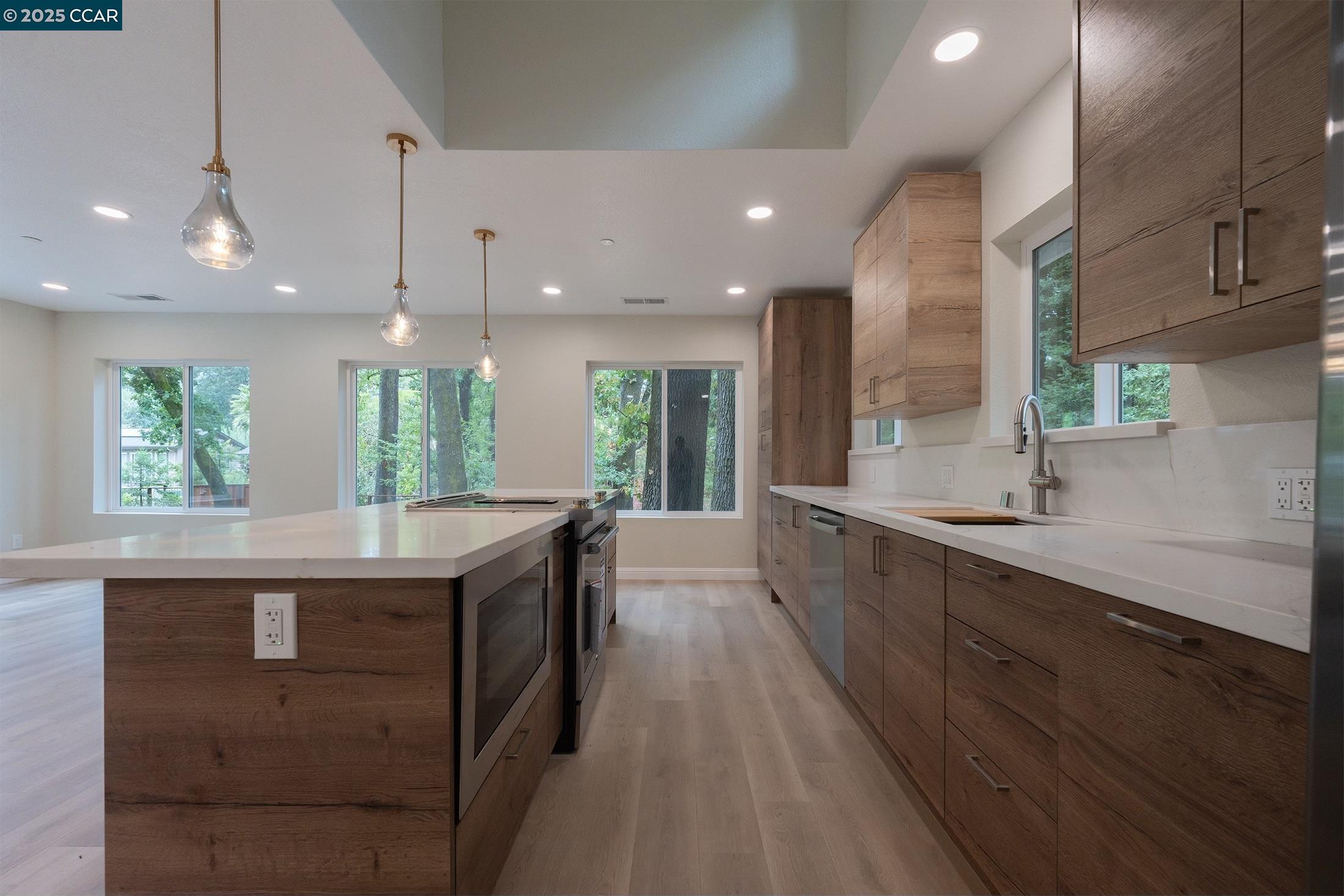 1244 A Stone Valley Road Alamo, CA 94507 - Photo 11 of 20 a large kitchen with a large counter top a sink a window and stainless steel appliances