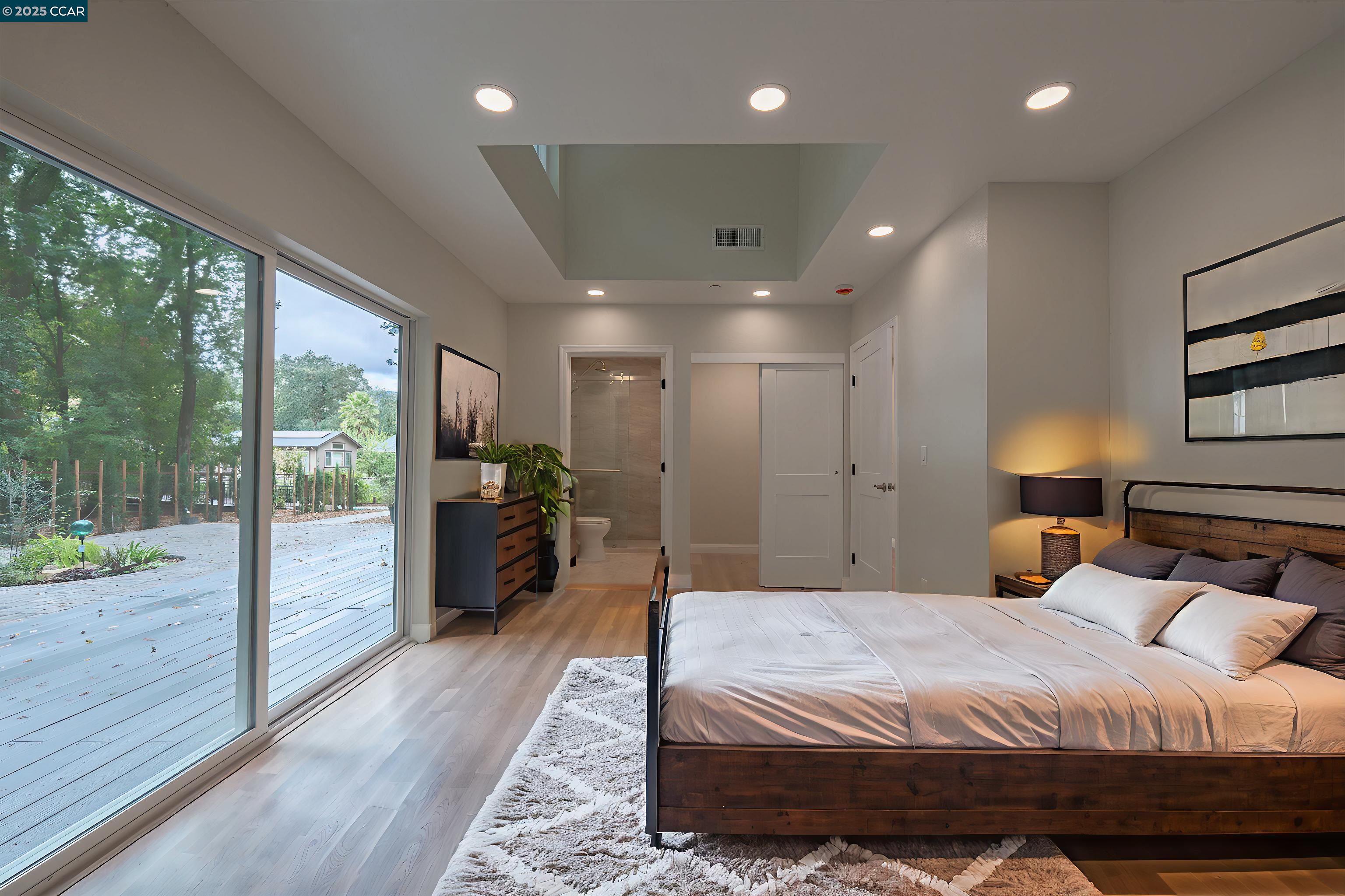 1244 A Stone Valley Road Alamo, CA 94507 - Photo 13 of 20 a large bedroom with a bed and wooden floor