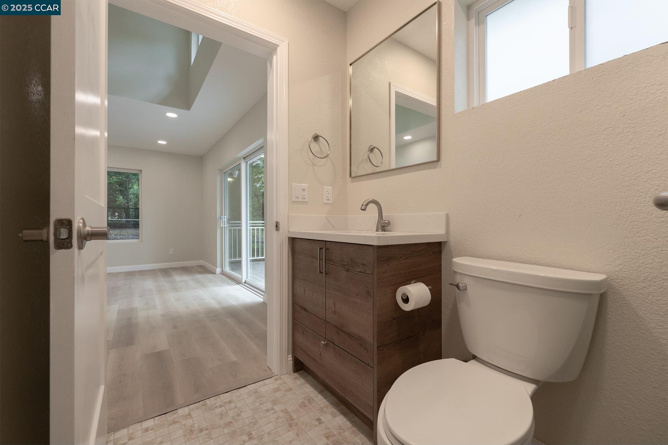 1244 A Stone Valley Road Alamo, CA 94507 - Photo 19 of 20 a bathroom with a toilet a sink and mirror