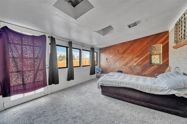 a spacious bedroom with a bed and window