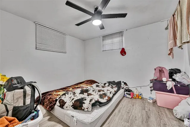 a bedroom with bed and a chandelier