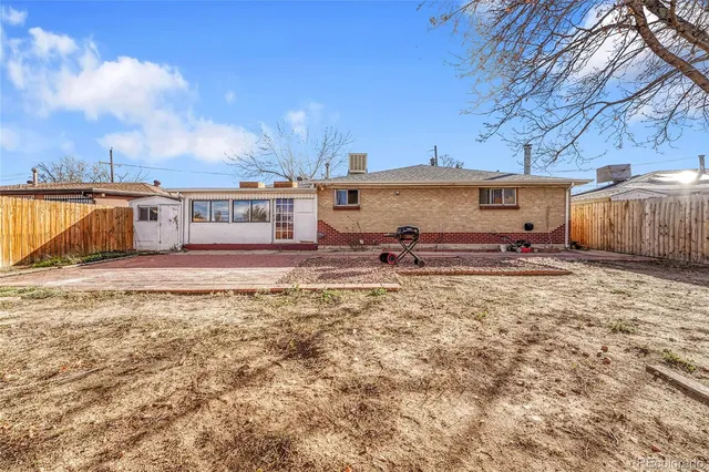 a view of a house with a yard covered in snow