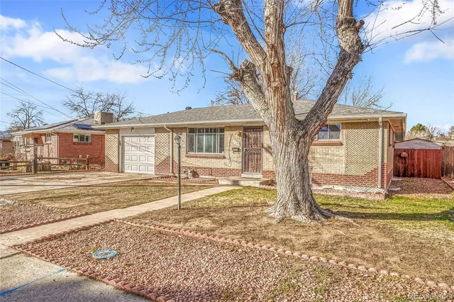 a view of a house with a tree in the yard