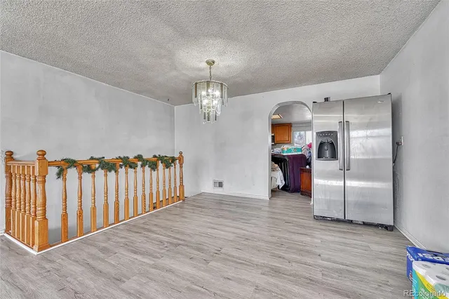 a view of a refrigerator in kitchen and wooden floor