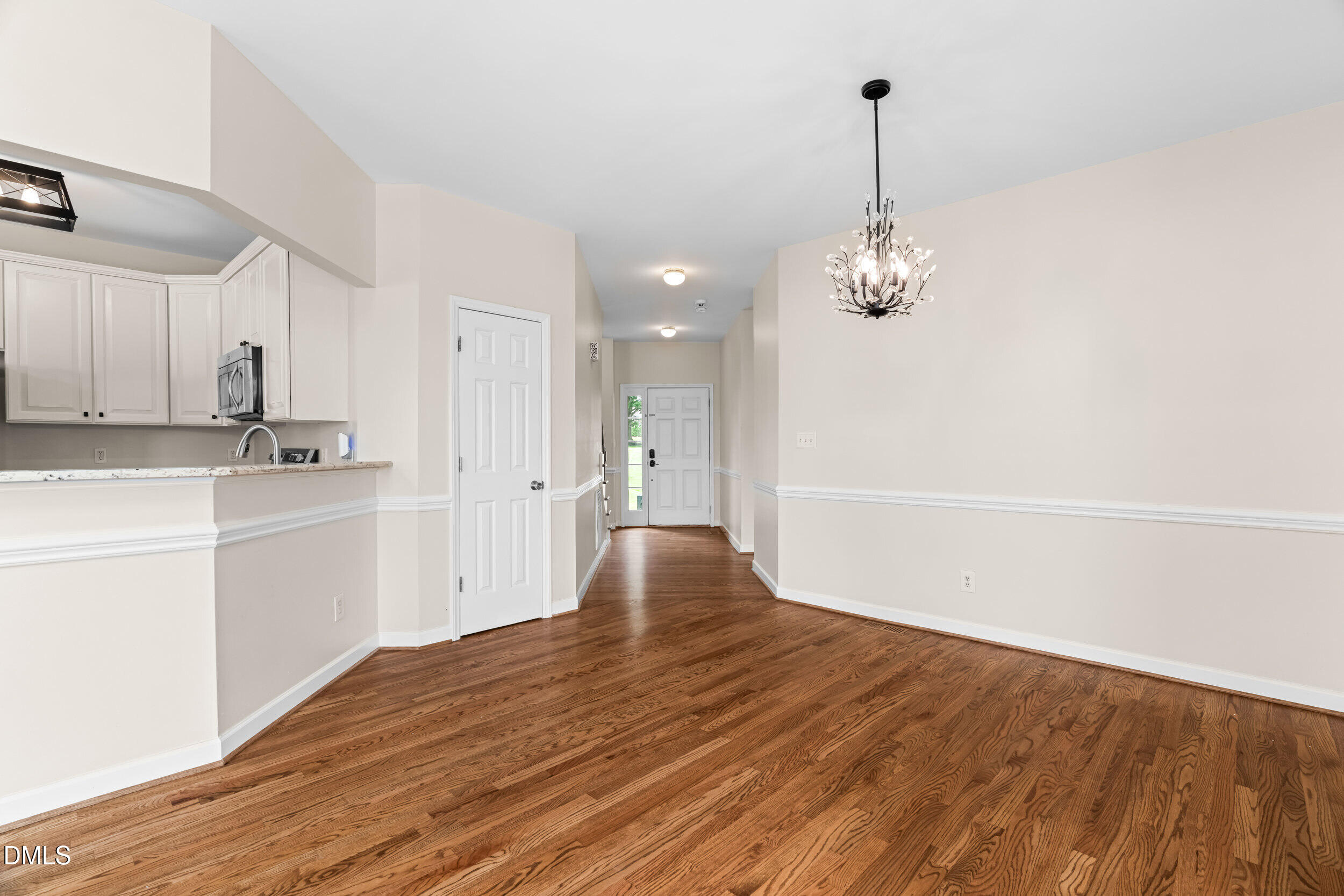 744 Seastone Street Raleigh, NC 27603 - Photo 14 of 53 a view of an empty room with kitchen and window