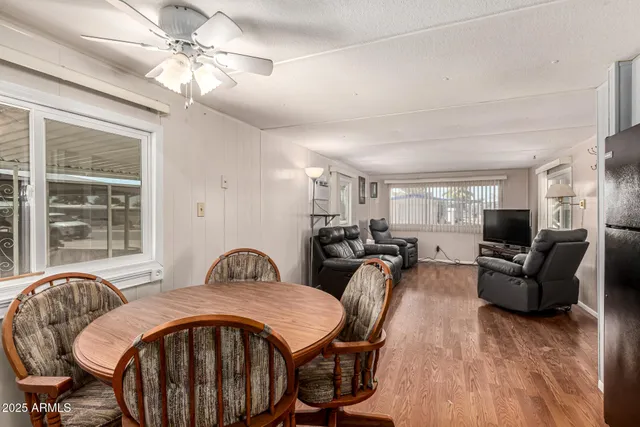a kitchen with kitchen island a refrigerator stove microwave and a dining table