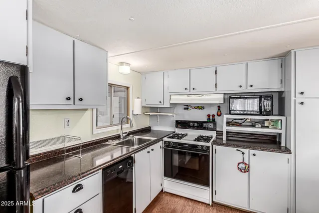 a kitchen with cabinets appliances and a counter space