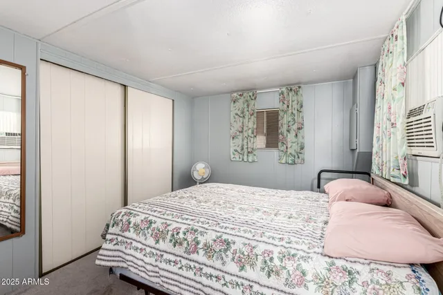 a bedroom with a bed and a window