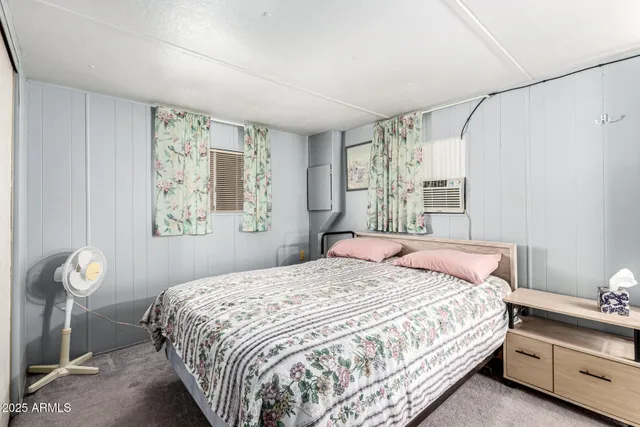 a bedroom with a bed and a mirror