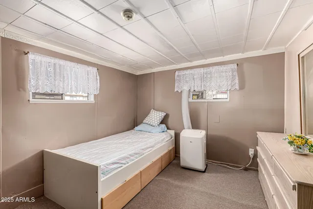 a bed room with a bed and a chair