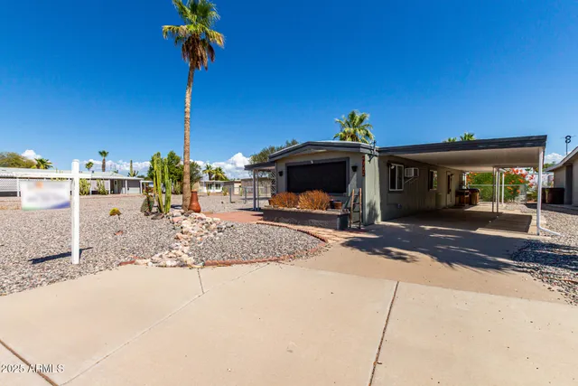 a view of a house with floor to ceiling windows and a basket ball poll