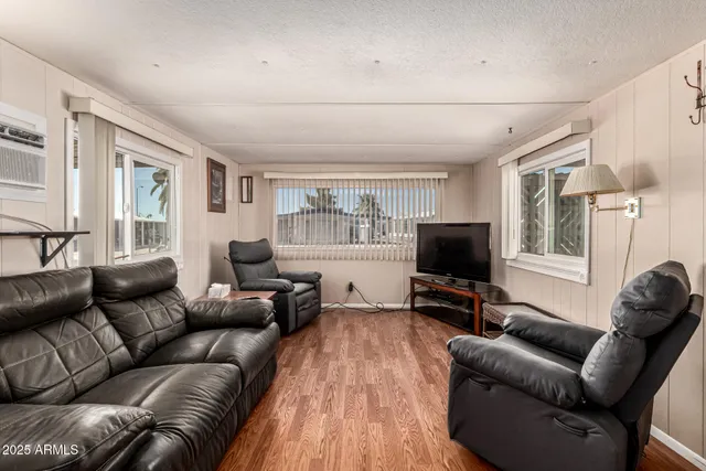a living room with furniture window and a flat screen tv