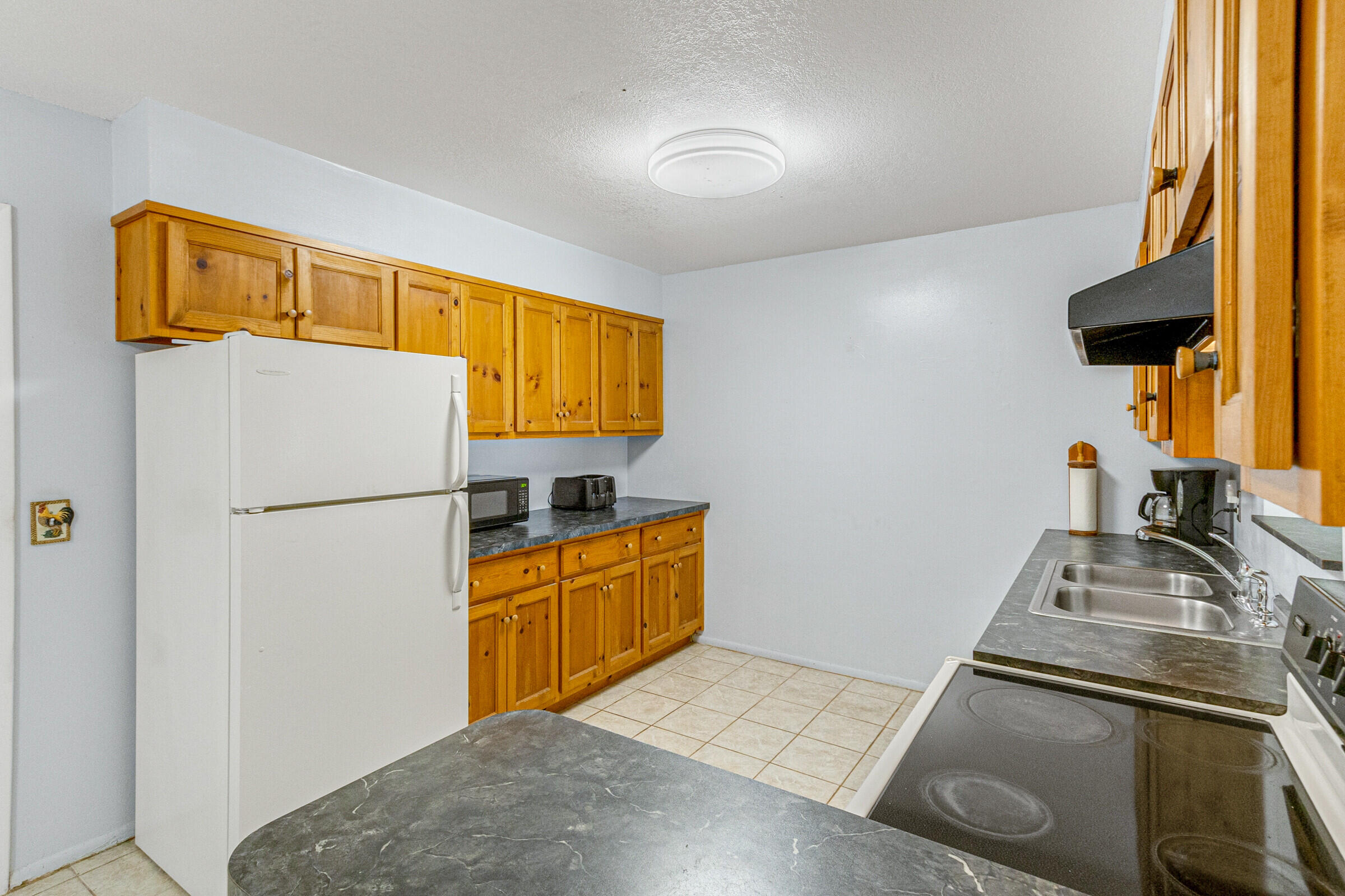 542 Sylvia Road Melbourne, FL 32904 - Photo 11 of 37 a kitchen with stainless steel appliances granite countertop a refrigerator and a stove top oven
