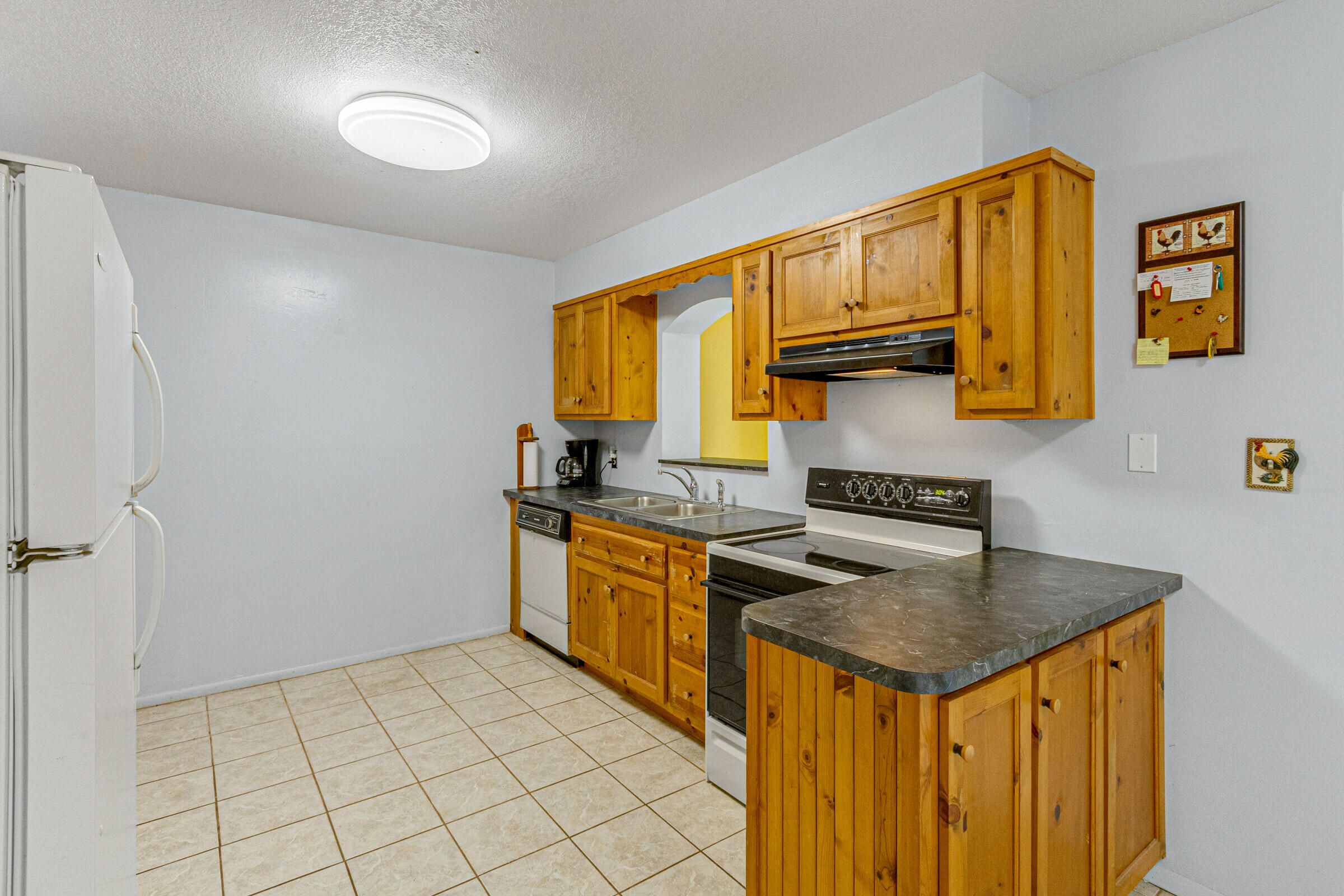 542 Sylvia Road Melbourne, FL 32904 - Photo 12 of 37 a kitchen that has a sink and a stove top oven