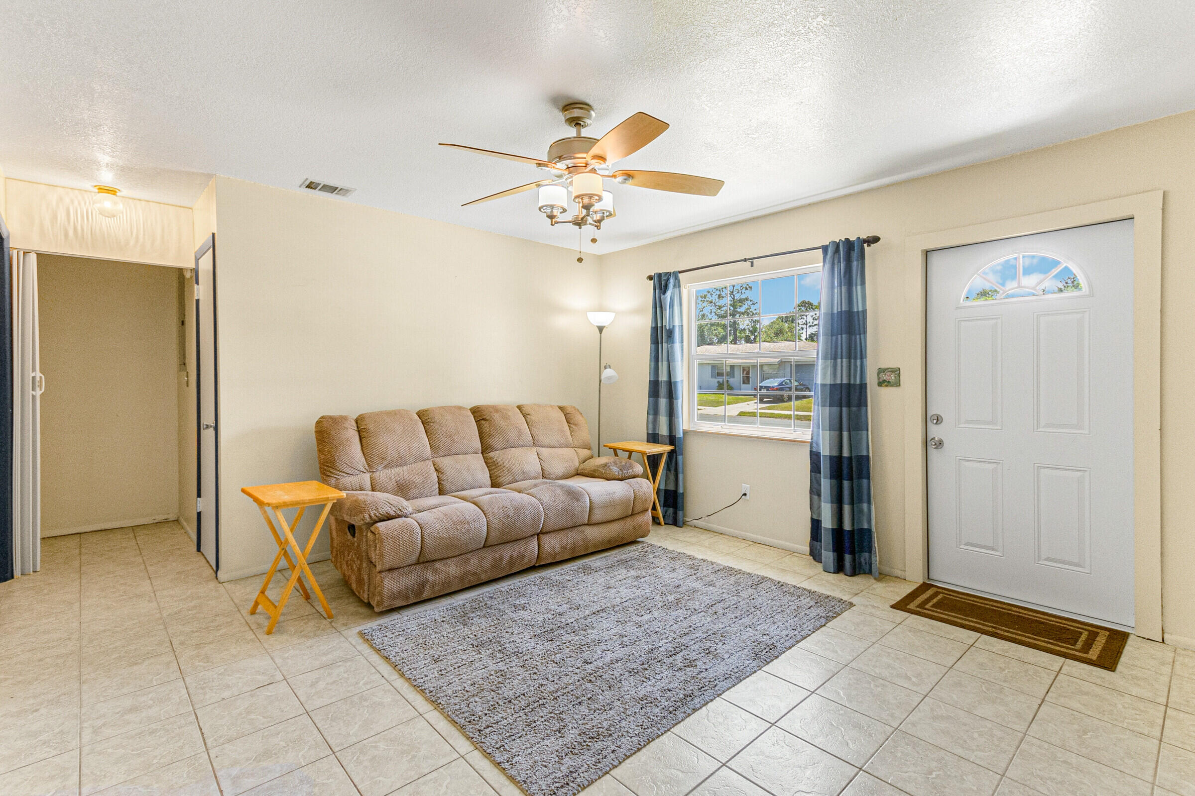 542 Sylvia Road Melbourne, FL 32904 - Photo 13 of 37 a living room with furniture and wooden floor