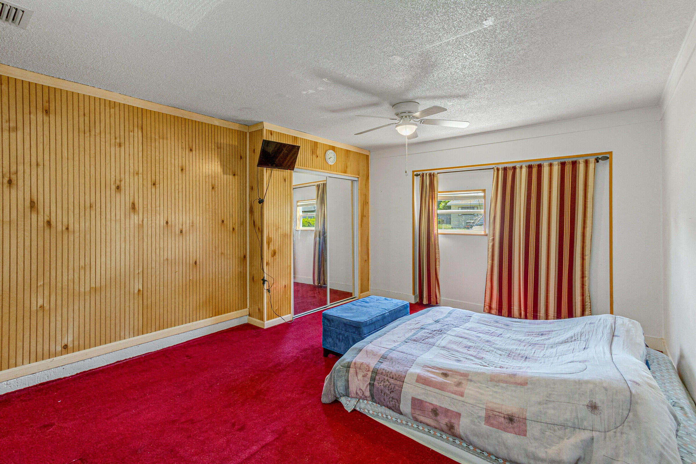 542 Sylvia Road Melbourne, FL 32904 - Photo 17 of 37 a bedroom with a bed and a chandelier