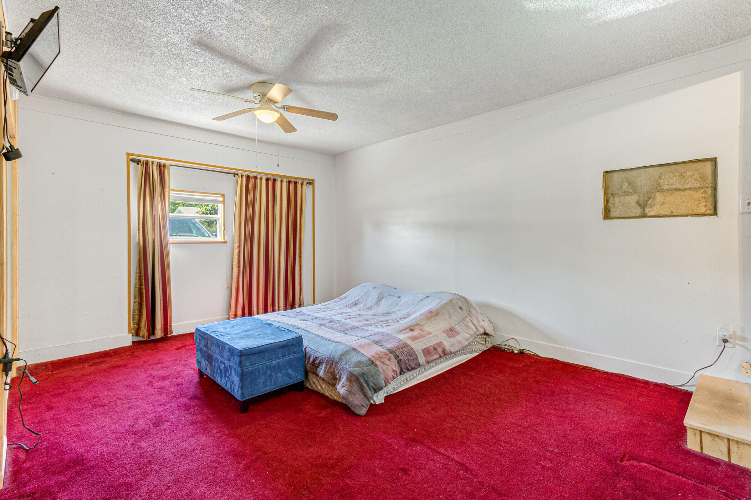 542 Sylvia Road Melbourne, FL 32904 - Photo 21 of 37 a bedroom with a bed and a chandelier