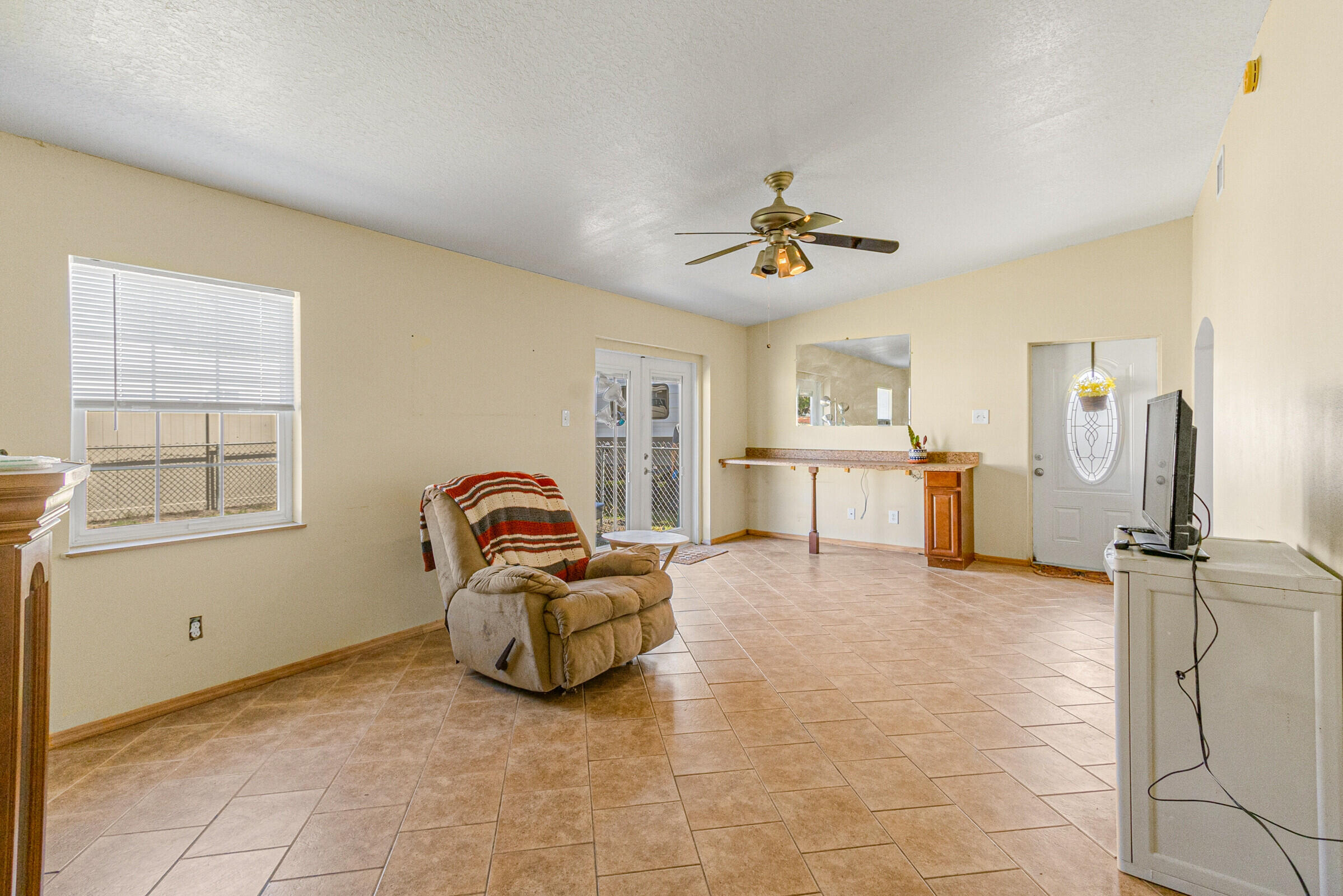 542 Sylvia Road Melbourne, FL 32904 - Photo 25 of 37 a living room with furniture gym equipment and a window