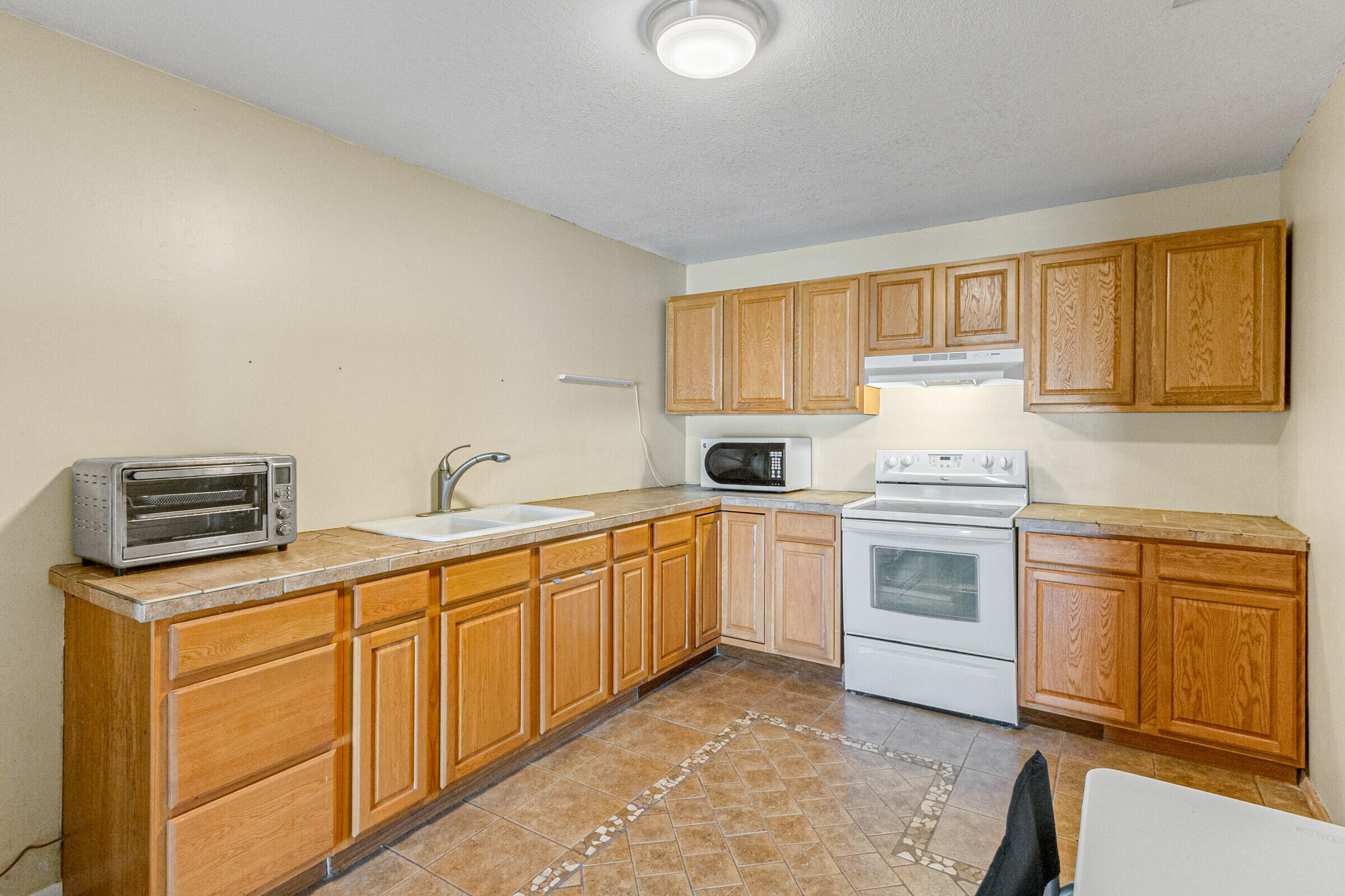 542 Sylvia Road Melbourne, FL 32904 - Photo 31 of 37 a kitchen with cabinets appliances and a window