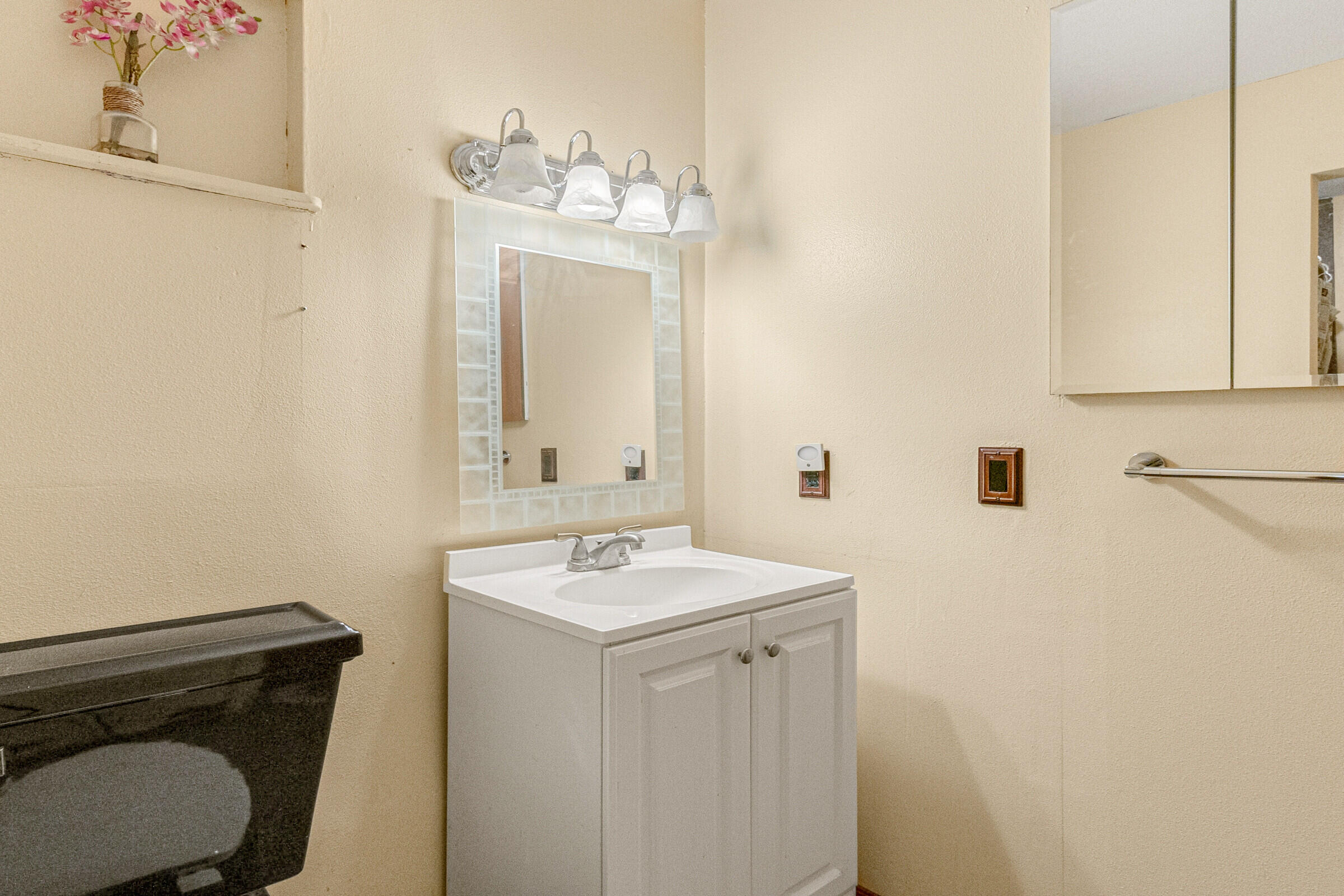 542 Sylvia Road Melbourne, FL 32904 - Photo 35 of 37 a bathroom with a sink a toilet and mirror
