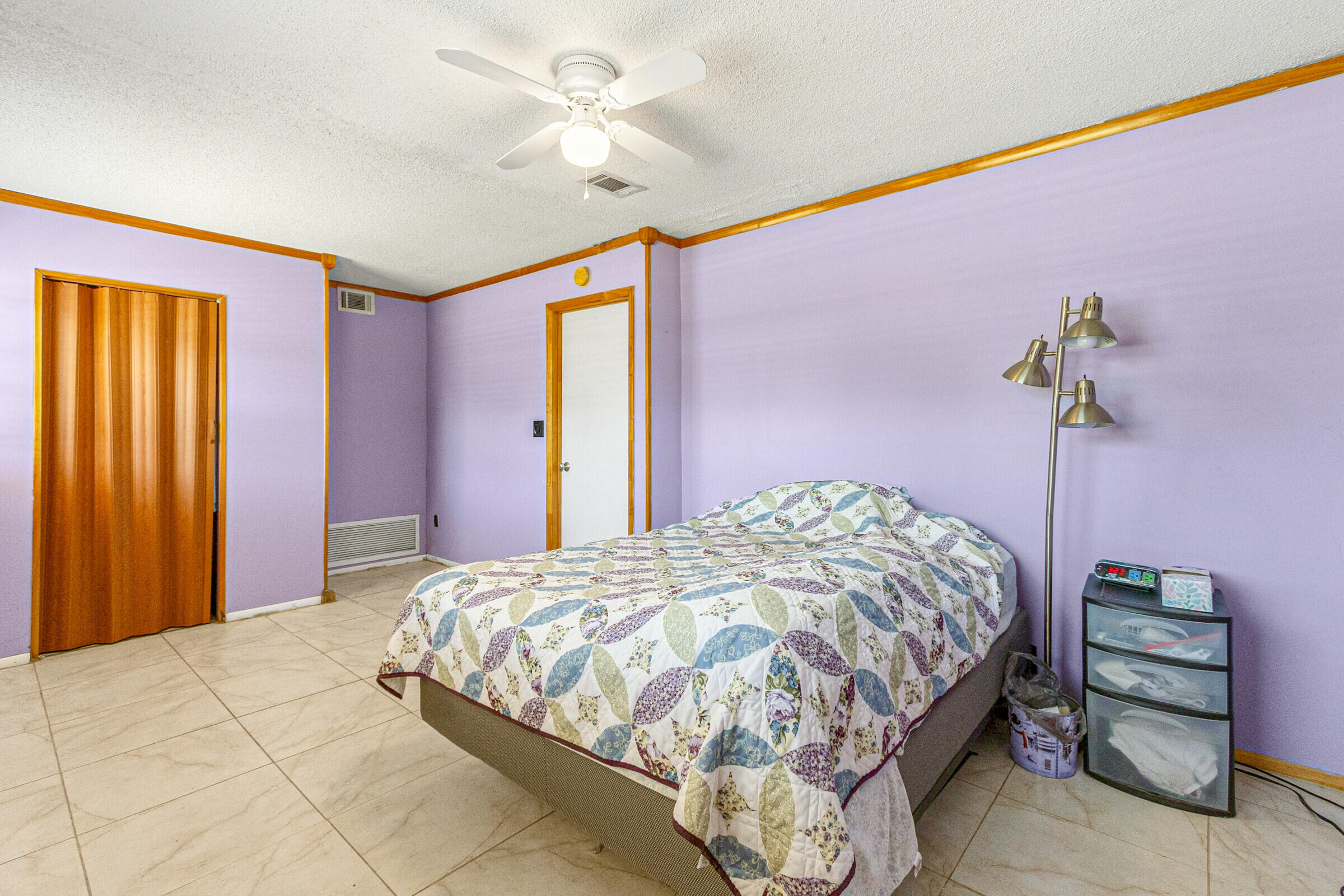 542 Sylvia Road Melbourne, FL 32904 - Photo 37 of 37 a bedroom with a bed and a chandelier