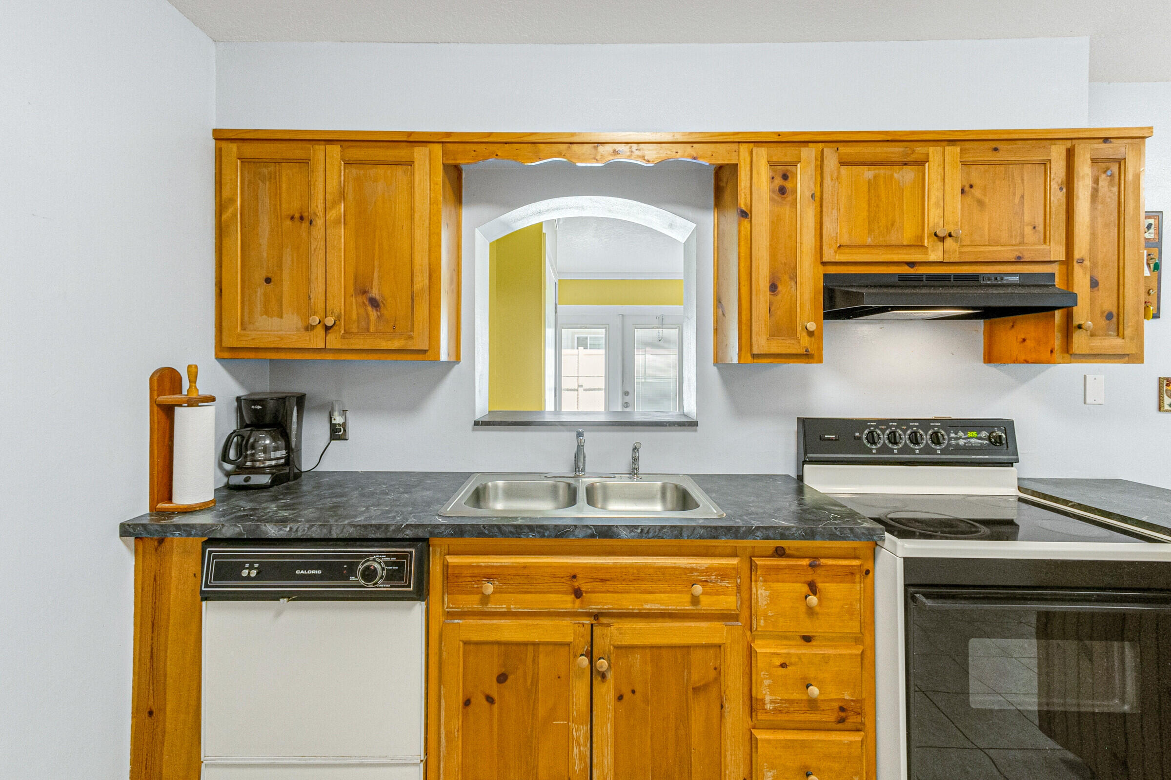 542 Sylvia Road Melbourne, FL 32904 - Photo 10 of 37 a kitchen with stainless steel appliances granite countertop a sink stove and cabinets