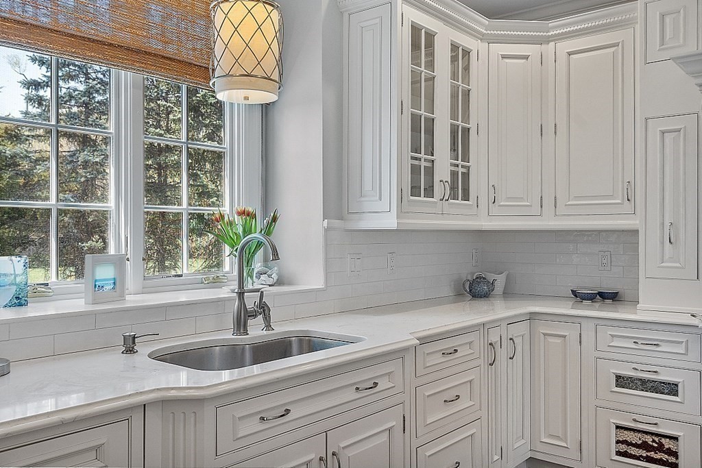 490 Lexington Road Concord, MA 01742 - Photo 12 of 40 a kitchen with stainless steel appliances white cabinets and a sink