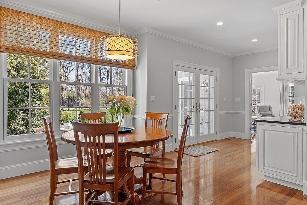 490 Lexington Road Concord, MA 01742 - Photo 13 of 40 a dining room with furniture a chandelier and wooden floor