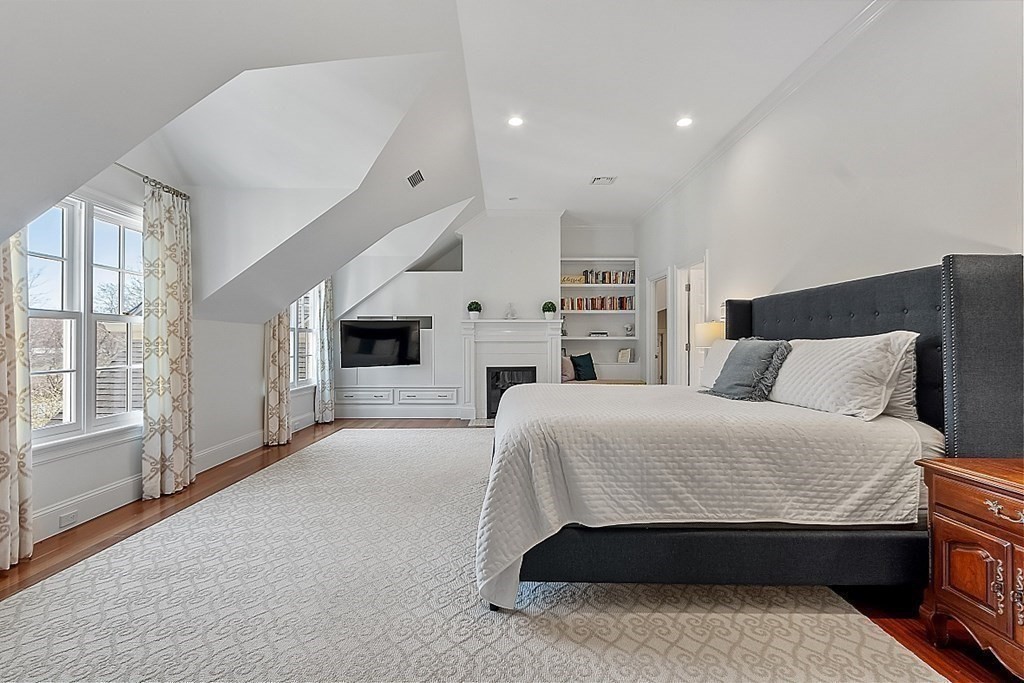 490 Lexington Road Concord, MA 01742 - Photo 19 of 40 a spacious bedroom with a bed and wooden floor