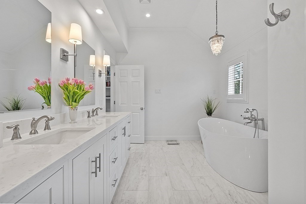 490 Lexington Road Concord, MA 01742 - Photo 22 of 40 a spacious bathroom with a double vanity sink and a mirror