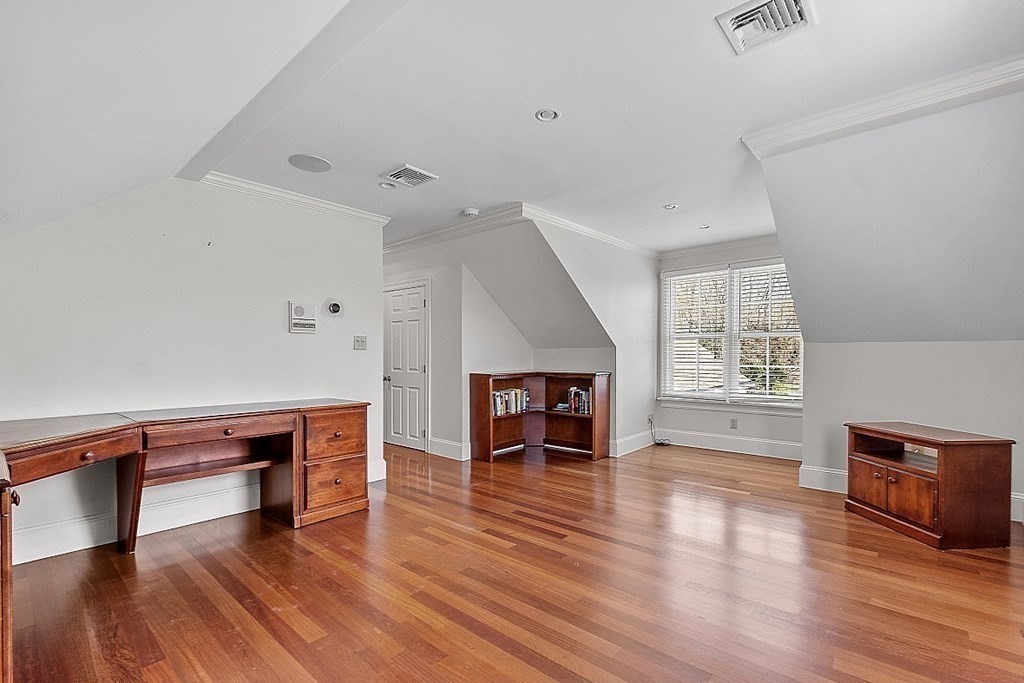 490 Lexington Road Concord, MA 01742 - Photo 25 of 40 an empty room with wooden floor fireplace and windows