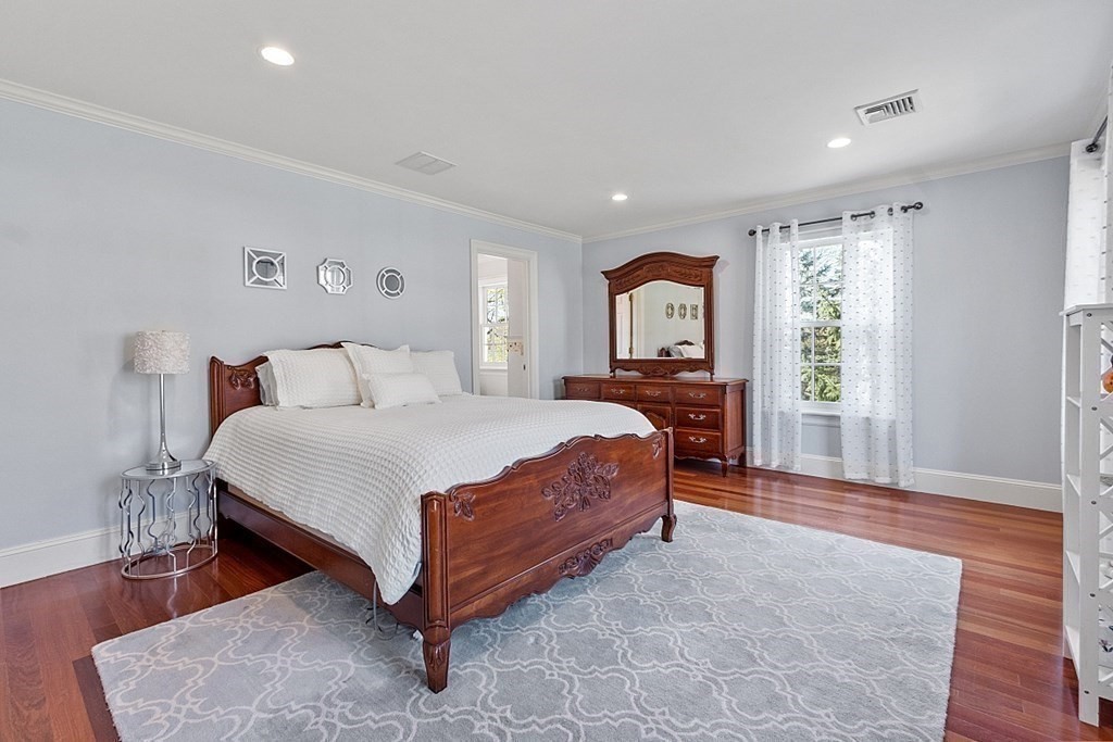 490 Lexington Road Concord, MA 01742 - Photo 26 of 40 a spacious bedroom with a large bed and a window