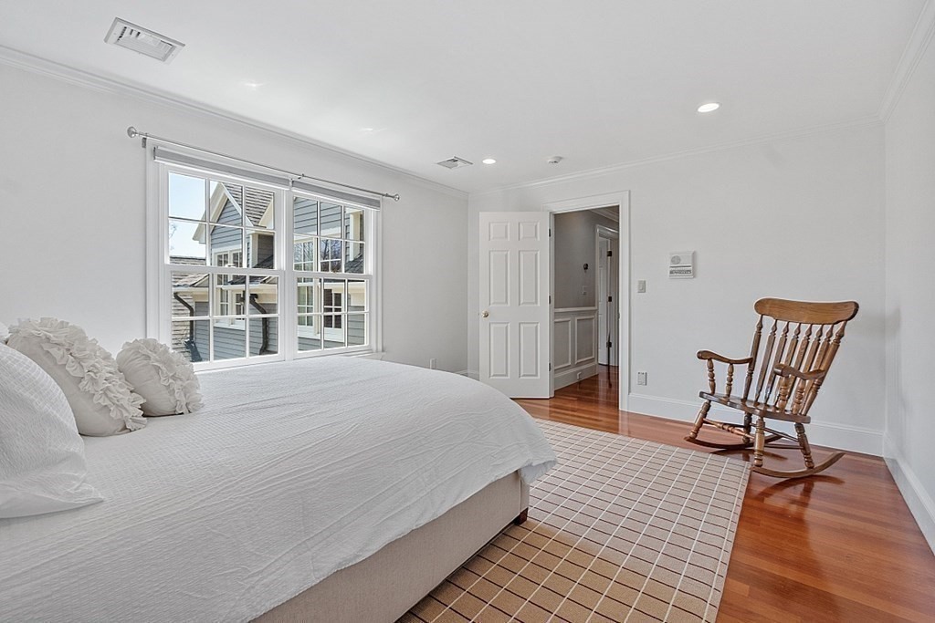 490 Lexington Road Concord, MA 01742 - Photo 28 of 40 a bedroom with a bed and a chair