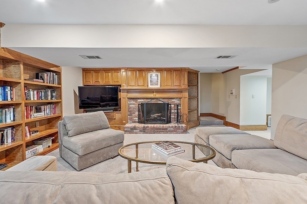 490 Lexington Road Concord, MA 01742 - Photo 32 of 40 a living room with furniture and a fireplace