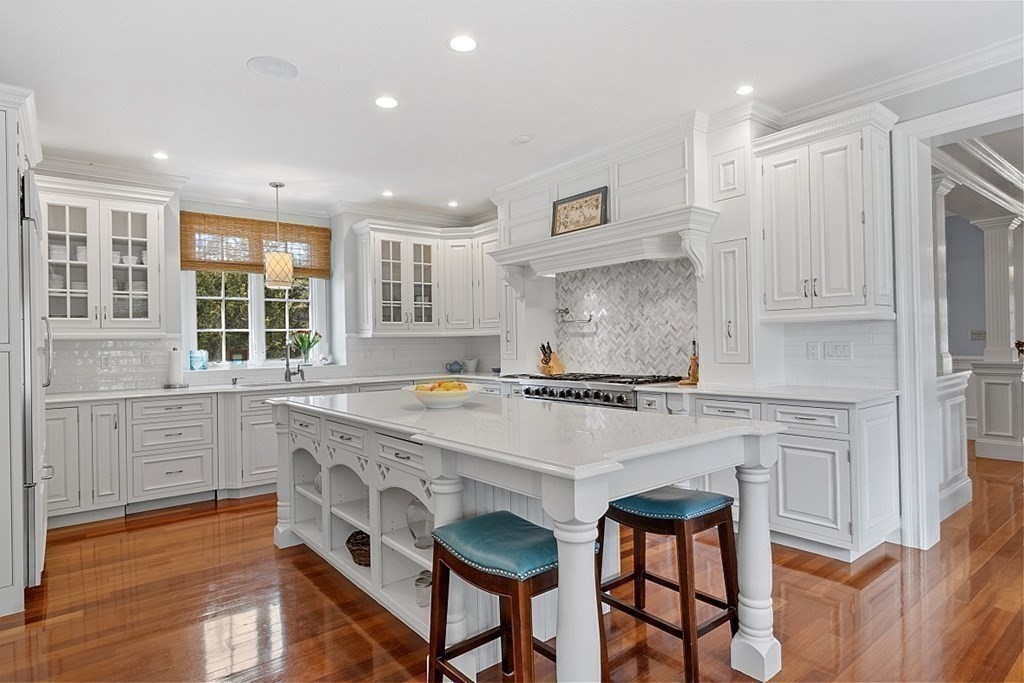 490 Lexington Road Concord, MA 01742 - Photo 10 of 40 a kitchen with stainless steel appliances granite countertop a stove a sink dishwasher and a refrigerator with wooden floor