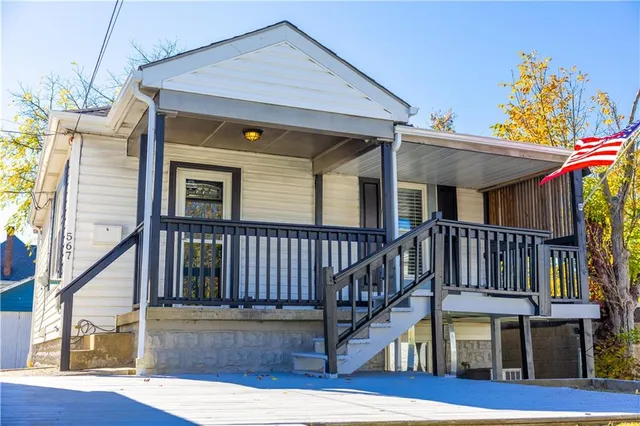 a view of a house with wooden deck