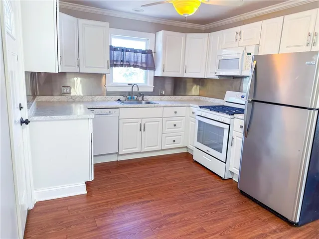a view of an empty room with wooden floor