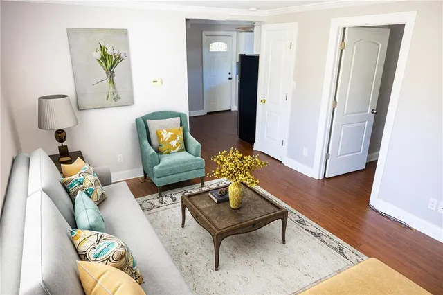 a living room with furniture and wooden floor