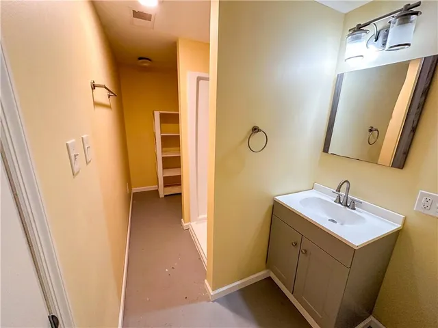 a bathroom with a shower and a sink