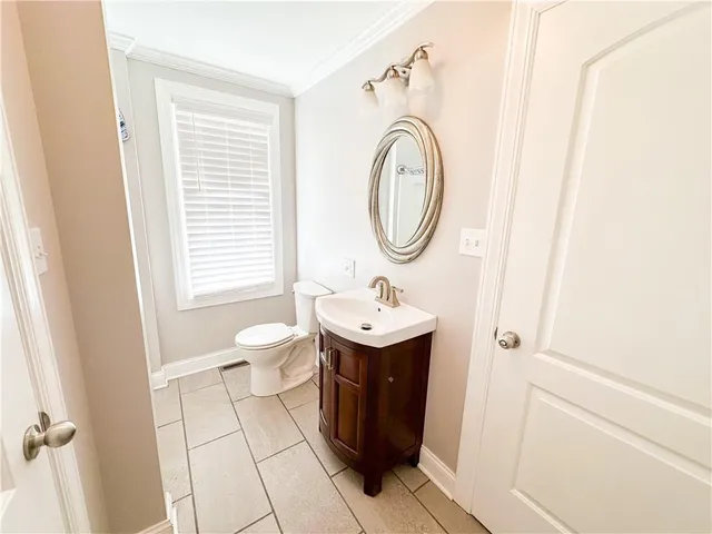 a bathroom with a sink a toilet and a window