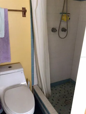 a bathroom with a toilet and a shower
