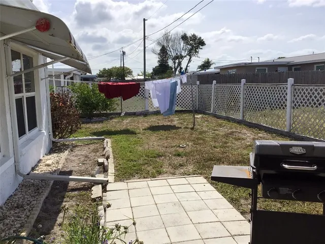 a view of a backyard with sitting area
